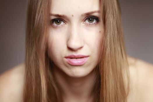 Emotional girl portrait on the brown background