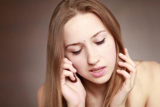 The beautiful girl is talking on the mobile phone. Girl portrait. Woman portrait.