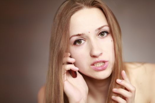 The beautiful girl is talking on the mobile phone. Girl portrait. Woman portrait.