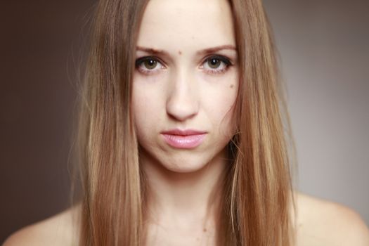 Emotional girl portrait on the brown background