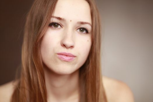 Emotional girl portrait on the brown background