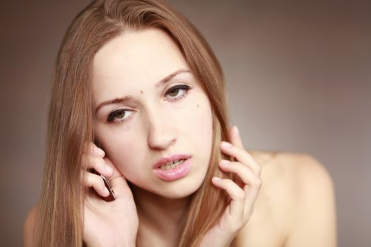 The beautiful girl is talking on the mobile phone. Girl portrait. Woman portrait.