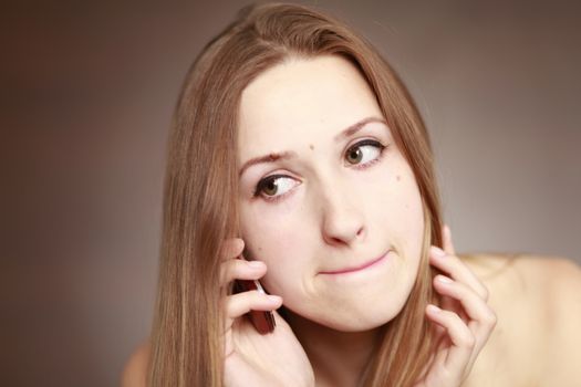 The beautiful girl is talking on the mobile phone. Girl portrait. Woman portrait.