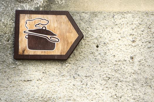 a wooden sign indicating a restaurant on the right