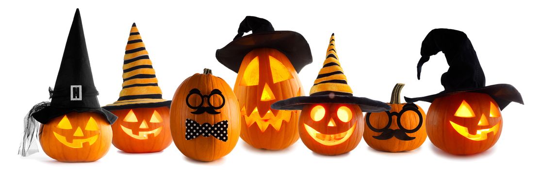 A collection of Jack O Lantern Halloween pumpkins with various different designs and witches hat in a row isolated on white background