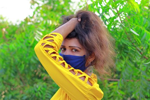 Fashionable portrait of a indian girl model with wearing face mask Protection against disease, coronavirus.