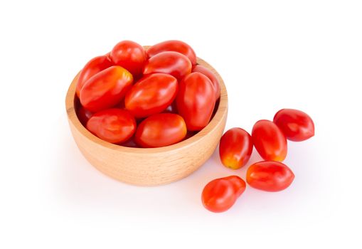 Fresh red cherry tomatoes in wood bowl, selective focus