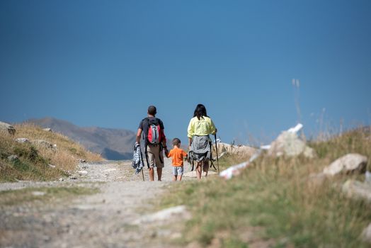 Family walk in sunny day in Els Cortals de Encamp on Andorra, Pyrennes Mountians.