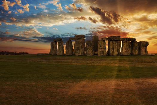 Sun setting behind Stonehenge Stone Circle