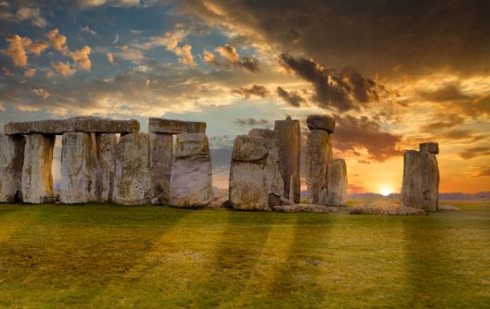 Sun setting behind Stonehenge Stone Circle