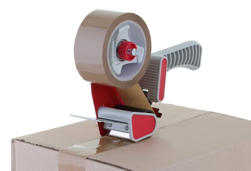 A red tape gun on box on white background