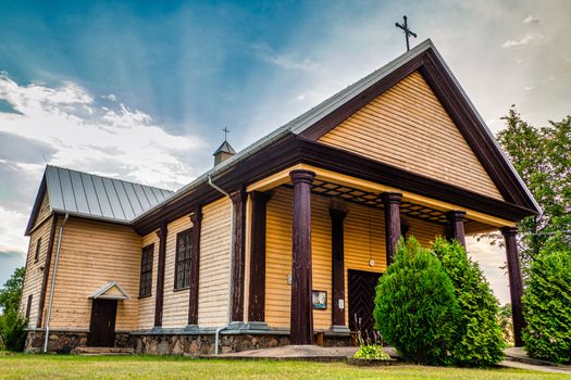 A Little Countryside Yellow Wooden Church with Sunset Clouds.