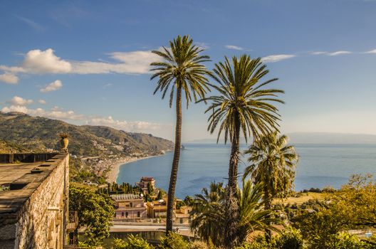 View from the cliffs of the Sicilian coast near the city of taormina with its vegetation and constructions