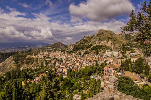 Panoramic view of the sicilian territory and the sicilian city of taormina and the vegetation and mountains that surround it