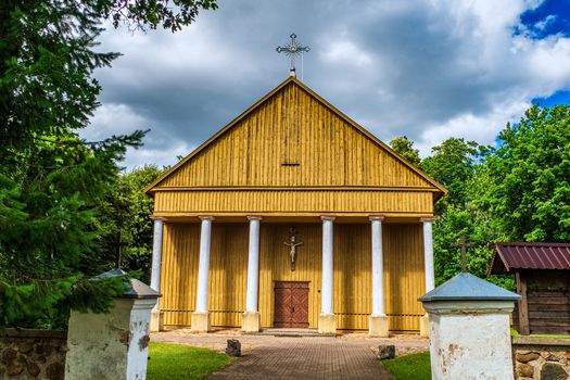Yellow Countryside Wooden Church with Beautiful Clouds, Lithuania.