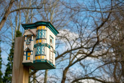 A Colorful and Detailed Birdhouse Made to Look Like a Real House