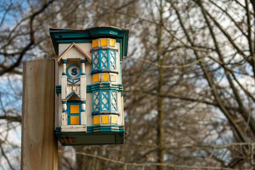 A Colorful and Detailed Birdhouse Made to Look Like a Real House