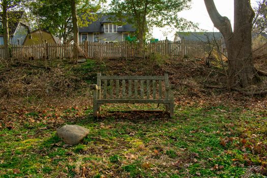 An Old Wooden Park Bench Covered in Moss in a Suburban Park in Pennsylvania