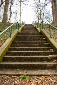 Looking Up Concrete Steps With a Gree Railing Covered in Foliage in a Suburban Park in Pennsylvania