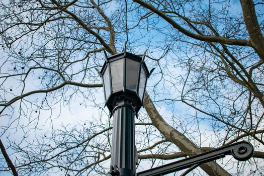 An Old Fashioned Black Metal Lamp Post on a Clear Blue Sky In Suburban Pennsylvania