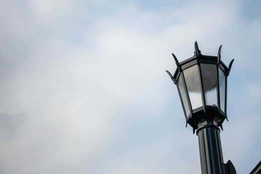 An Old Fashioned Black Metal Lamp Post on a Clear Blue Sky In Suburban Pennsylvania