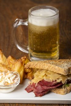 reuben sandwich on a plate with fries