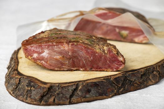 pastrami meat on a wooden chopping board