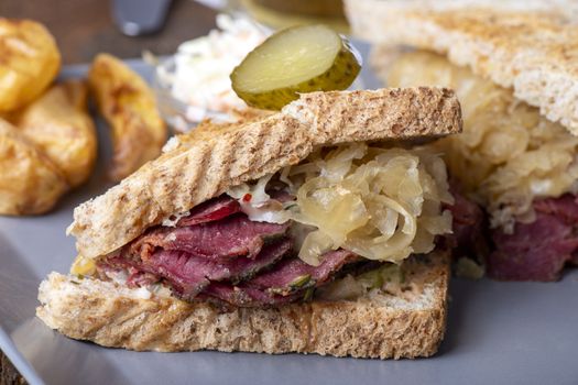 reuben sandwich on a plate with fries