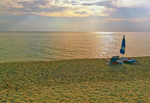 Sunbed and umbrella on the beach , Mediteranean sea. Greece