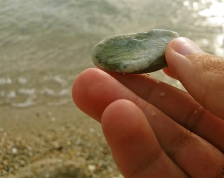 Beautiful stone in the hand, Exctracted from the sea.