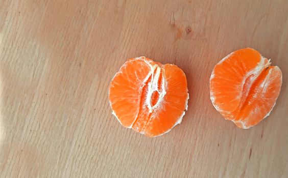 Peeled clementines on a wooden background, Copy space