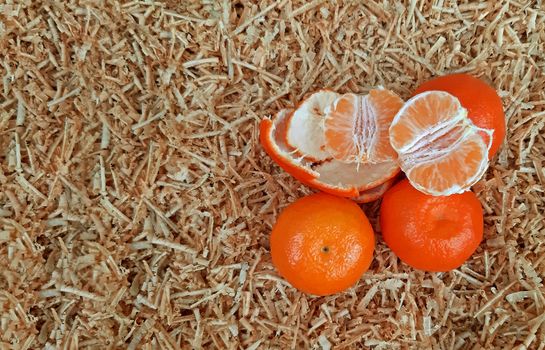 Clementines on a background of sawdust