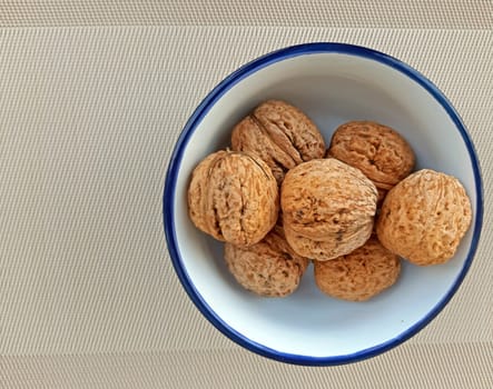 a plate of nuts on canvas background.