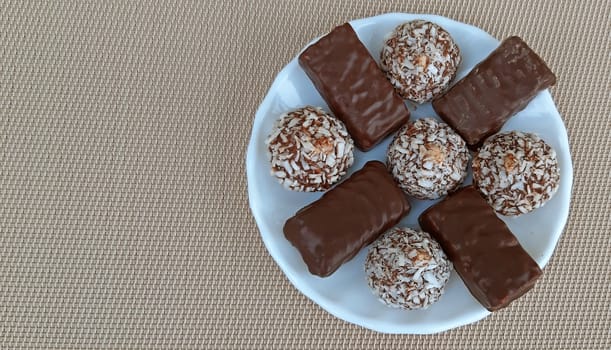Delicious chocolate candies in a plate. Copy space.