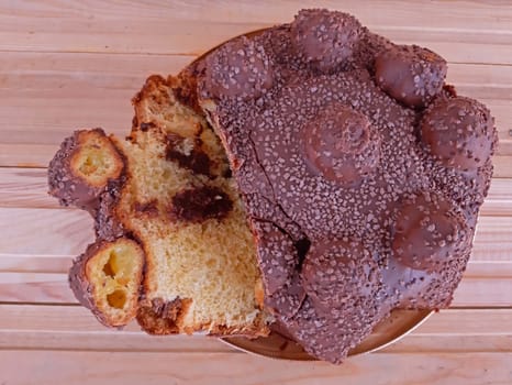 Cake with tasty chocolate on wooden background.