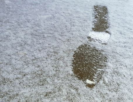 Human footprints in the snow, winter background.