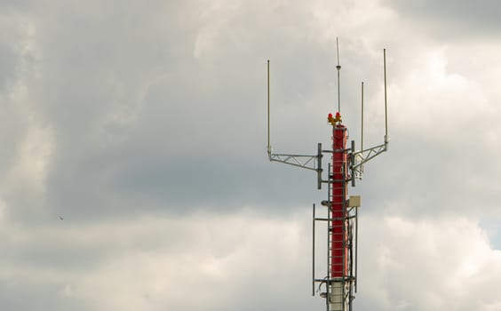 Telecommunication tower on the cloudy sky. Communication technology.