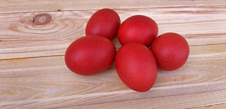 Red eggs on wooden background, Easter holiday.