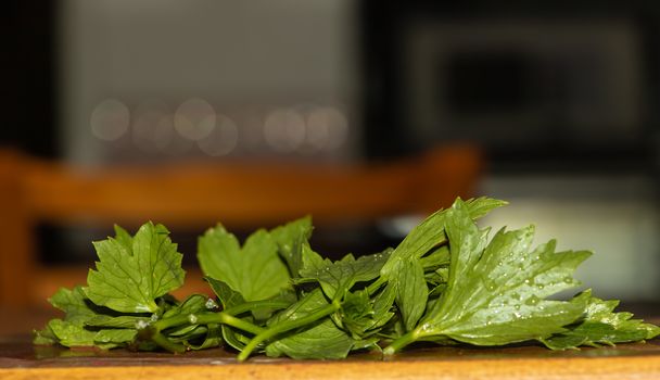 Chopped lovage in the kitchen, cooking process.