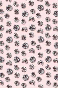 donuts on a pink background top view. Flat lay of delicious nibbled chocolate donuts. used as donut banner or poster background, not pattern