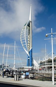 Portsmouth, UK - September 8, 2020: The landmark Spinnaker Tower overlooking Gunwharf Quays full of shoppers and sightseers on a sunny weekday afternoon on the South coast of Hampshire.  