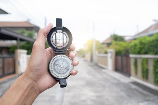 man holding compass on blurred background. for activity lifestyle outdoors freedom or travel tourism and inspiration backpacker alone tourist travel or navigator image.