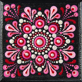 Mandala dot art painting on wood tiles. Beautiful mandala hand painted by colorful dots on black wood. National patterns with acrylic paints, handwork, dot painting. Abstract dotted background