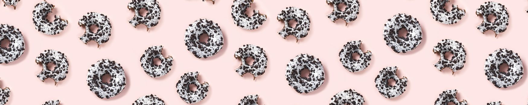 donuts on a pink background top view. Flat lay of delicious nibbled chocolate donuts. used as donut banner or poster background, not pattern