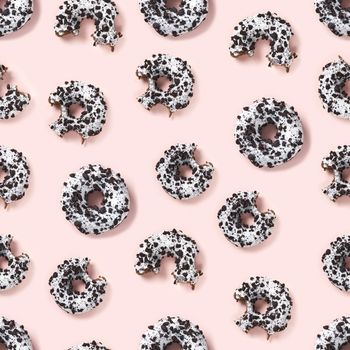quality seamless pattern of donuts on a pink background top view. Flat lay of delicious nibbled chocolate donuts. used as donut banner, print pattern or poster background