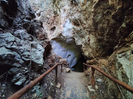 horizontal photo of cave entrance with handrail in Thaailand