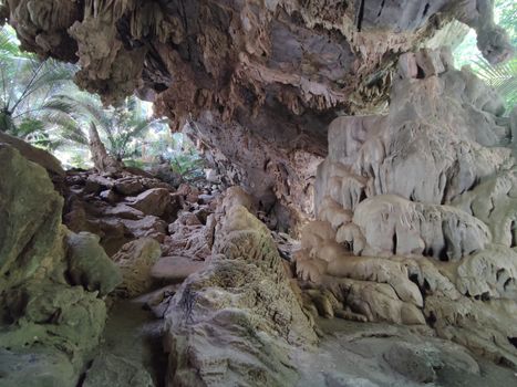 Horizontal photo of cave with stalactites and stalagmites in Thailand
