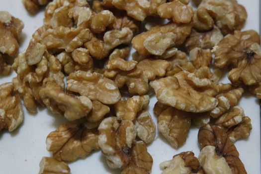 Close-up top view of peeled walnut on a white background. peeled walnut without shell ready to eat dry fruit.