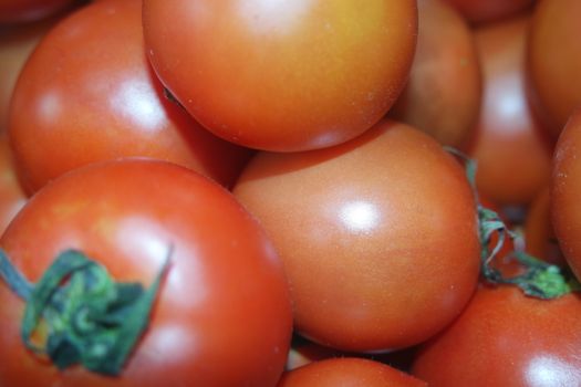Close-up view of red tomatoes in market for sale. A fruit background for text and advertisements
