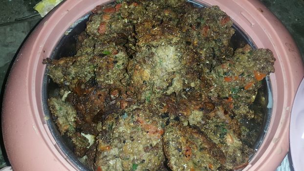 Closeup view with selective focus on delicious spicy fried round kebab served in a ceramic plate